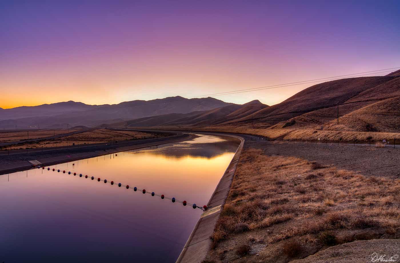 Photo of sunset over a levee in Kern County, California.